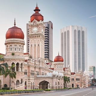 Vast ornate moorish style building with burgundy coloured minarets