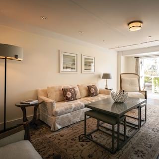 A sunny garden view through wide open doors dominates the far end of the vista suite’s spacious living room