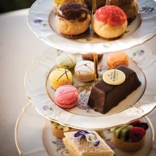Tiered afternoon-tea platter with brightly coloured varied confectionary