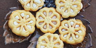 Birds-eye-view of flower shaped biscuits served on a ceramic leaf platter
